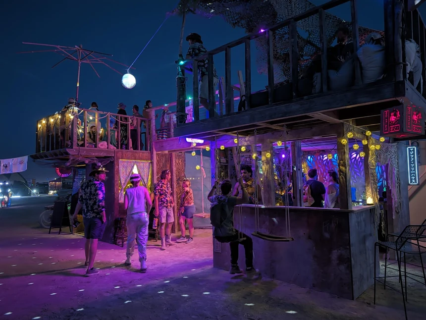 The bar at night, lit up and full of people